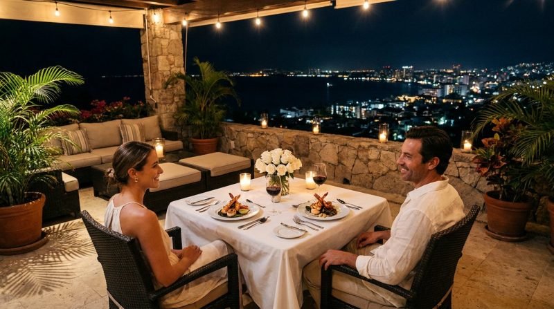 Romantic candlelit private dinner for two on a villa terrace overlooking Puerto Vallarta at night